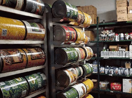 Metal shelves holding large cans of food