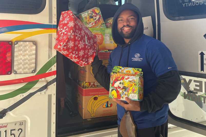 Boys and Girls Club staff member with presents