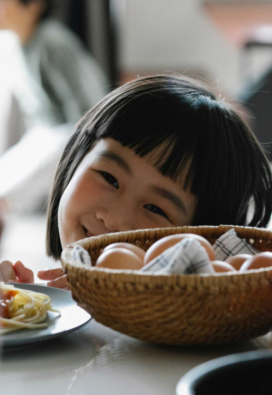 Girl Smiling while eating dinner