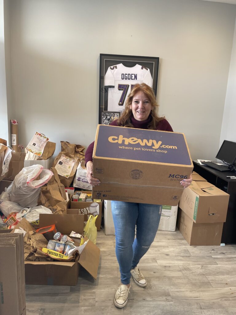 Katie at Remax Experience brings out a box of food donations.
